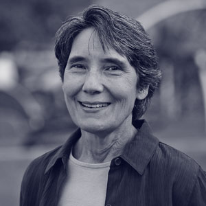 White middle aged woman with short hair smiling at the camera